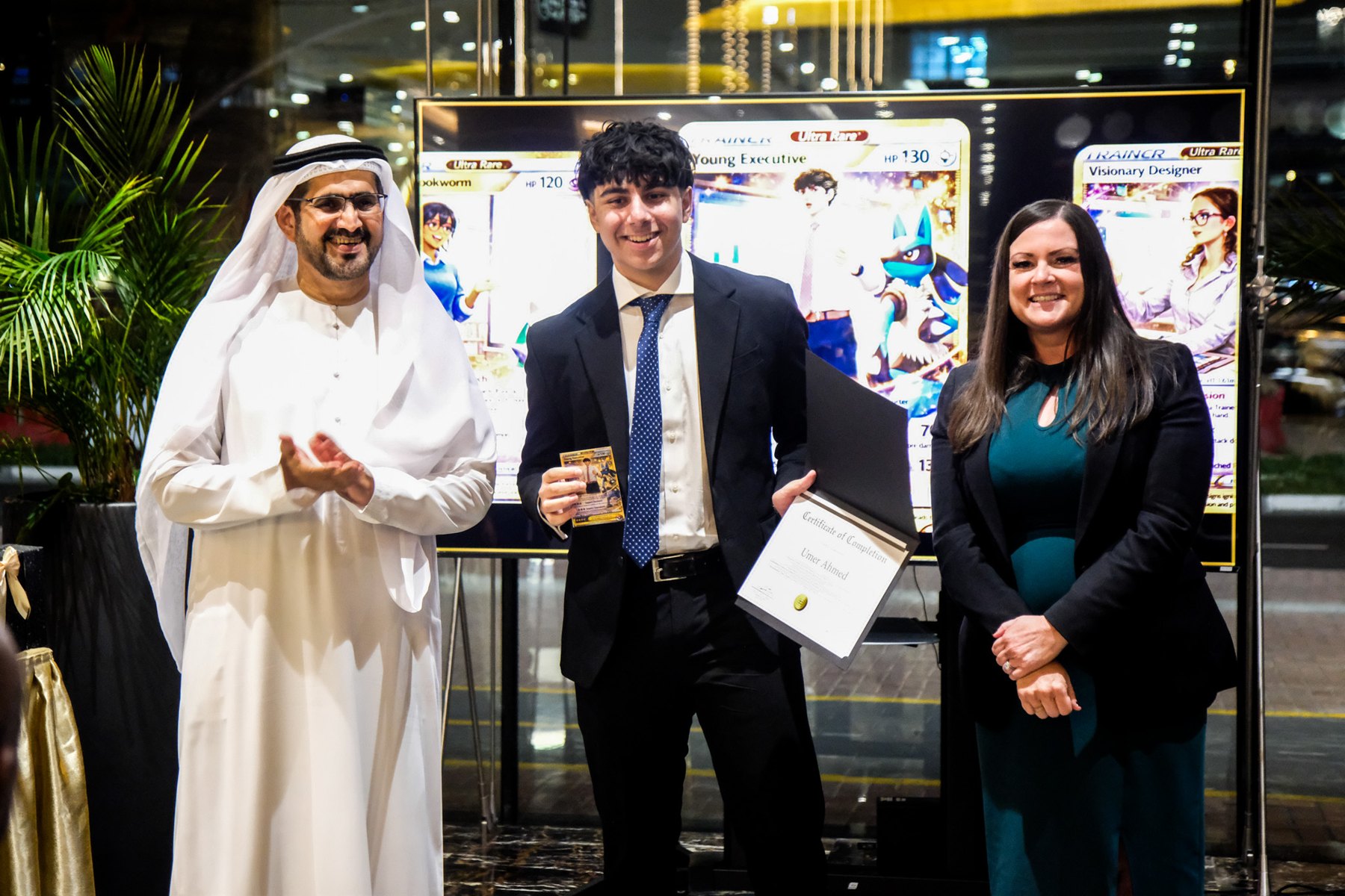 Certificate recipient with programme representatives at the ceremony